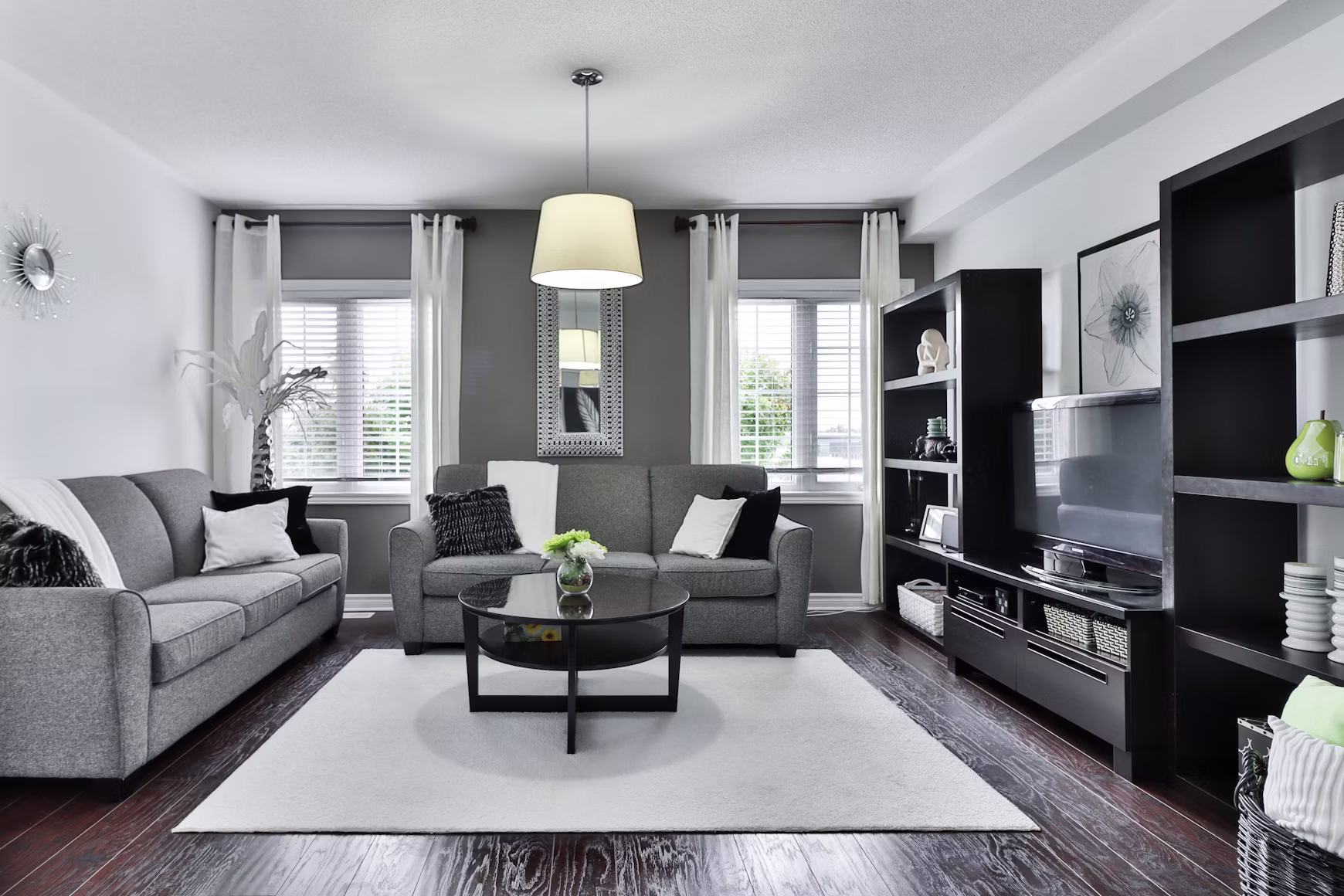 Clean, bright living room with couch and plants